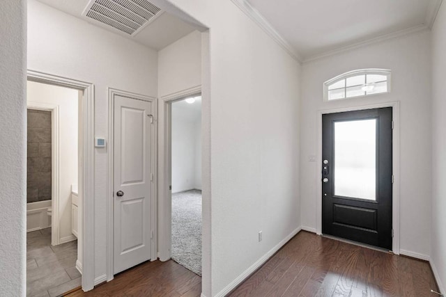 231 Prato Pl, Georgetown, TX 78628 - entryway with dark wood-style flooring and ornamental molding