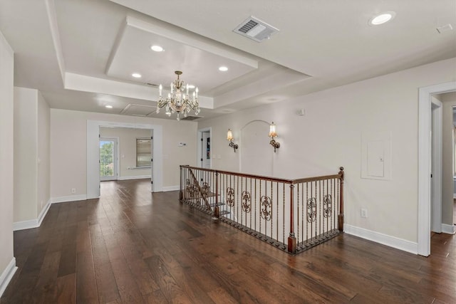 800 Canyon Bend Rd, Pflugerville, TX 78660 - hallway featuring a raised ceiling, dark wood-type flooring, a chandelier, recessed lighting, and baseboards