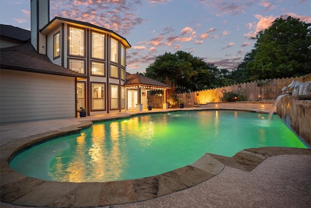 800 Canyon Bend Rd, Pflugerville, TX 78660 - pool at dusk featuring a fenced backyard and a patio area