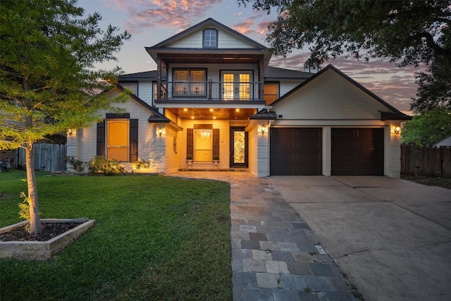 800 Canyon Bend Rd, Pflugerville, TX 78660 - view of front of home with a balcony, an attached garage, concrete driveway, and brick siding