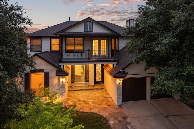 800 Canyon Bend Rd, Pflugerville, TX 78660 - view of front of property featuring a balcony, driveway, brick siding, roof with shingles, and a chimney
