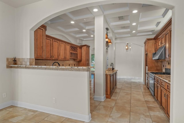 800 Canyon Bend Rd, Pflugerville, TX 78660 - kitchen with stainless steel range with gas stovetop, coffered ceiling, decorative backsplash, recessed lighting, and a peninsula