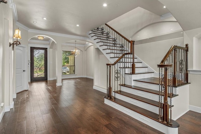 800 Canyon Bend Rd, Pflugerville, TX 78660 - entrance foyer with arched walkways, baseboards, wood-type flooring, a chandelier, and stairway