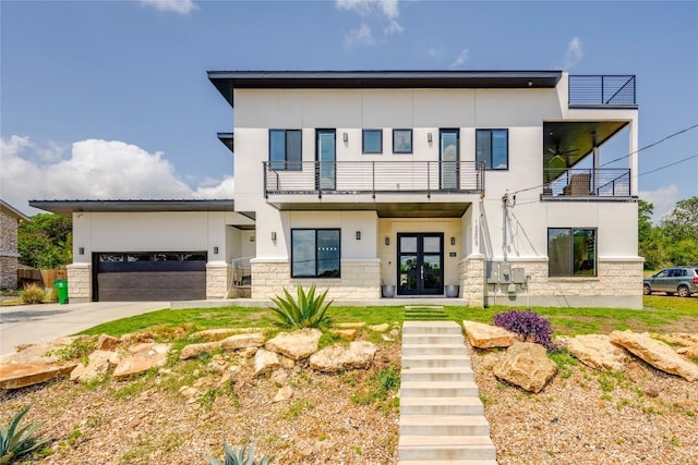 13209 Mansfield Dr, Austin, TX 78732 - contemporary home featuring french doors, a balcony, stone siding, and stucco siding