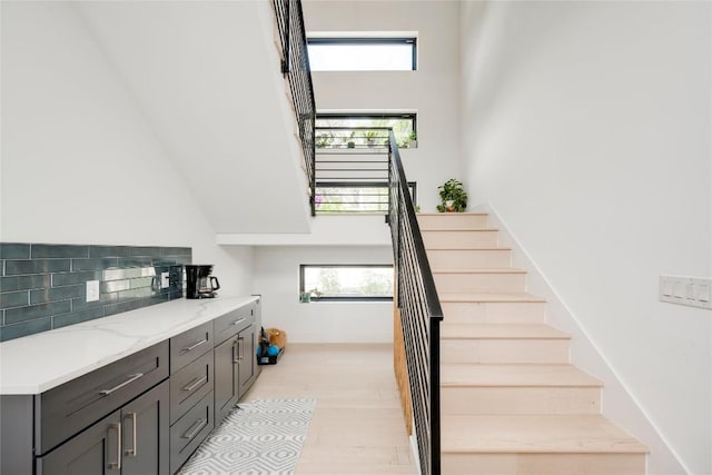 13209 Mansfield Dr, Austin, TX 78732 - stairs with a high ceiling and wood finished floors