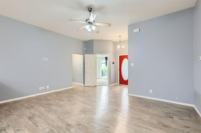 224 Copper Ln, Jarrell, TX 76537 - empty room featuring a ceiling fan, a chandelier, wood finished floors, and baseboards