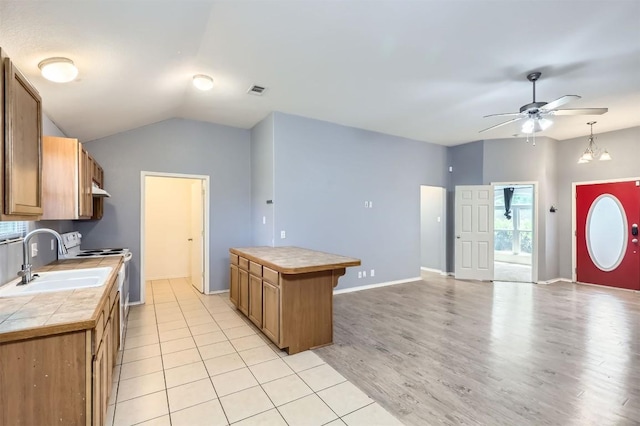 224 Copper Ln, Jarrell, TX 76537 - kitchen featuring white electric range oven, a sink, a ceiling fan, light wood-style floors, and tile countertops