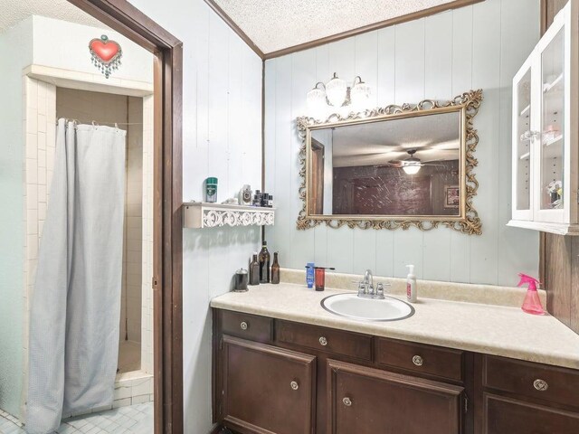 8622 Thunderbird Rd, Austin, TX 78736 - bathroom with ornamental molding, a shower stall, vanity, and a textured ceiling