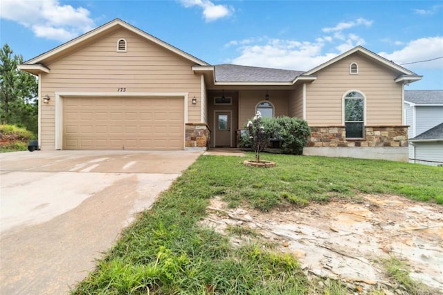 173 Kipahulu Dr, Bastrop, TX 78602 - single story home featuring stone siding, driveway, a garage, and a front yard