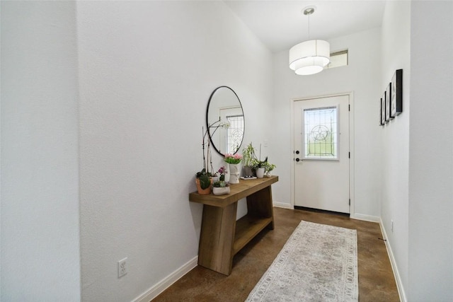 173 Kipahulu Dr, Bastrop, TX 78602 - entryway featuring baseboards, concrete floors, and a high ceiling