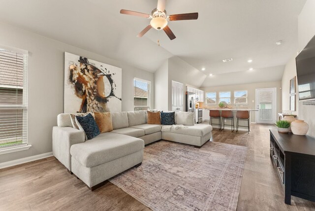 1910 Lummus Dr, Temple, TX 76504 - living room with light wood finished floors, plenty of natural light, lofted ceiling, ceiling fan, and recessed lighting