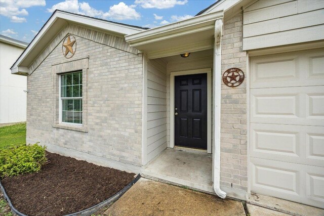 110 Rinehardt St, Hutto, TX 78634 - property entrance featuring brick siding and an attached garage