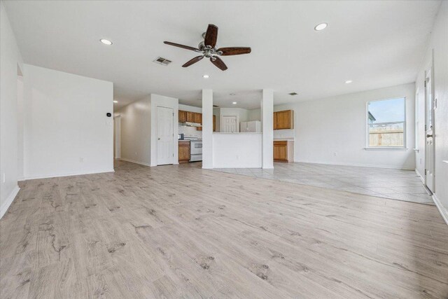 110 Rinehardt St, Hutto, TX 78634 - unfurnished living room featuring ceiling fan, recessed lighting, baseboards, and light wood-style floors