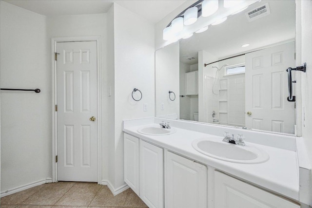 110 Rinehardt St, Hutto, TX 78634 - full bathroom featuring double vanity, baseboards, and tile patterned floors