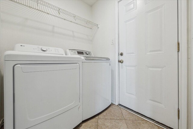 110 Rinehardt St, Hutto, TX 78634 - laundry area with independent washer and dryer and light tile patterned floors
