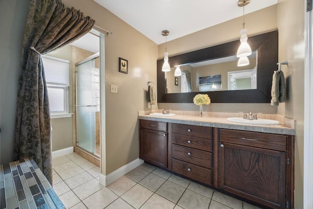 13210 Dime Box Trl, Austin, TX 78729 - full bath featuring tile patterned floors, double vanity, a stall shower, and baseboards