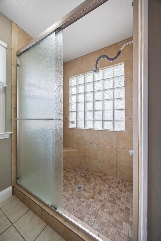 13210 Dime Box Trl, Austin, TX 78729 - full bathroom featuring a shower stall and tile patterned floors