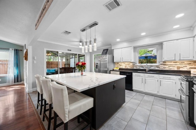13210 Dime Box Trl, Austin, TX 78729 - kitchen with appliances with stainless steel finishes, a sink, backsplash, plenty of natural light, and crown molding