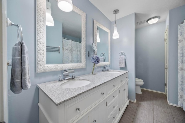 13210 Dime Box Trl, Austin, TX 78729 - bathroom with double vanity and toilet