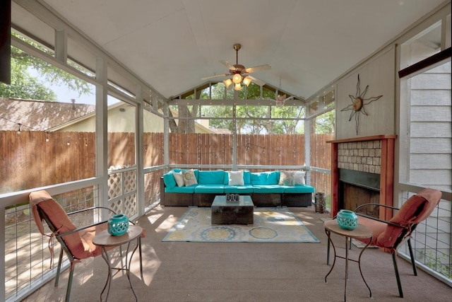 13210 Dime Box Trl, Austin, TX 78729 - sunroom featuring ceiling fan, an outdoor living space with a fireplace, lofted ceiling, and healthy amount of natural light