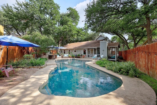 13210 Dime Box Trl, Austin, TX 78729 - view of swimming pool with a fenced backyard, a patio, and a sunroom