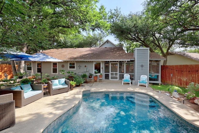 13210 Dime Box Trl, Austin, TX 78729 - view of pool featuring a sunroom, a patio area, and an outdoor living space