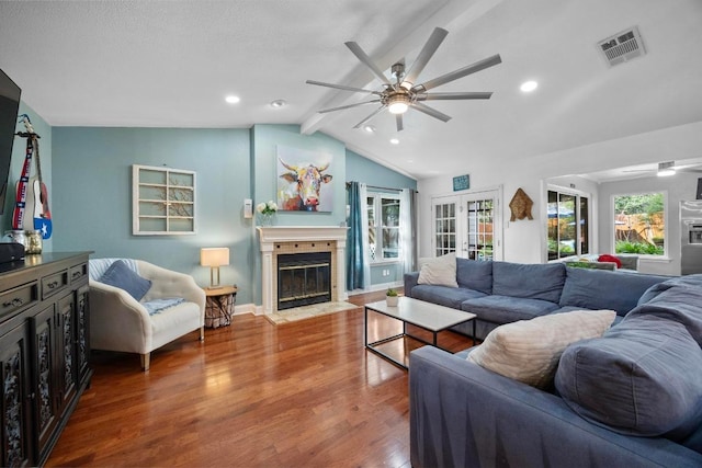 13210 Dime Box Trl, Austin, TX 78729 - living area with a fireplace with flush hearth, a ceiling fan, wood finished floors, recessed lighting, and baseboards