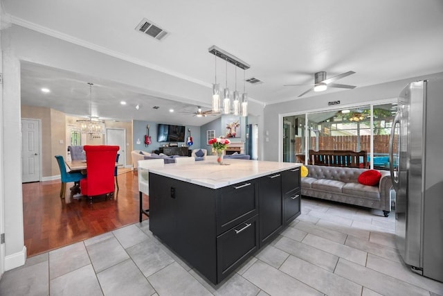 13210 Dime Box Trl, Austin, TX 78729 - kitchen featuring freestanding refrigerator, dark cabinets, open floor plan, a ceiling fan, and light tile patterned floors