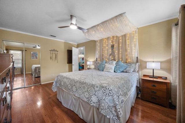 13210 Dime Box Trl, Austin, TX 78729 - bedroom featuring wood finished floors, ornamental molding, baseboards, a closet, and a ceiling fan