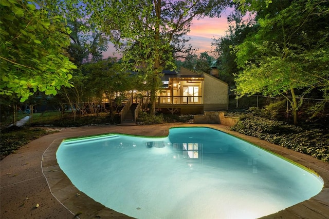 5902 Tumbling Cir, Austin, TX 78731 - pool at dusk featuring stairway, an outdoor pool, and a wooden deck