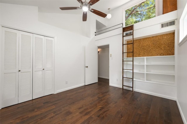 5902 Tumbling Cir, Austin, TX 78731 - unfurnished bedroom with wood finished floors, baseboards, a closet, a towering ceiling, and a ceiling fan