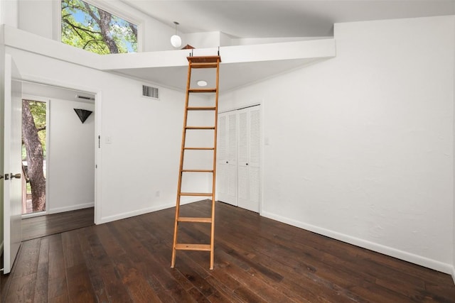 5902 Tumbling Cir, Austin, TX 78731 - unfurnished room with wood-type flooring, baseboards, and high vaulted ceiling