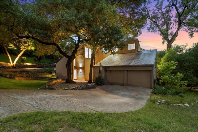 5902 Tumbling Cir, Austin, TX 78731 - view of front facade featuring driveway, metal roof, and a garage