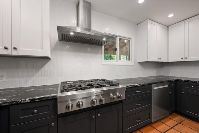 5902 Tumbling Cir, Austin, TX 78731 - kitchen featuring wall chimney exhaust hood, appliances with stainless steel finishes, white cabinetry, tasteful backsplash, and recessed lighting