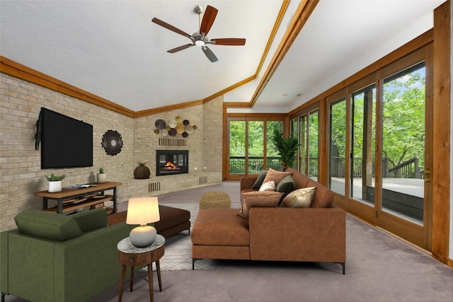 5902 Tumbling Cir, Austin, TX 78731 - carpeted living room featuring plenty of natural light, a ceiling fan, lofted ceiling, brick wall, and a fireplace