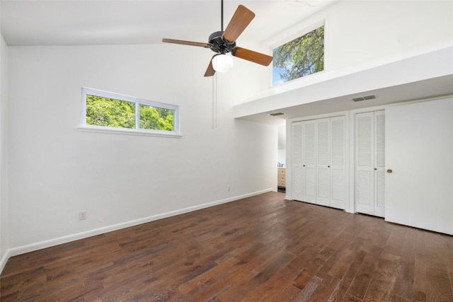 5902 Tumbling Cir, Austin, TX 78731 - unfurnished bedroom featuring two closets, high vaulted ceiling, wood finished floors, multiple windows, and baseboards