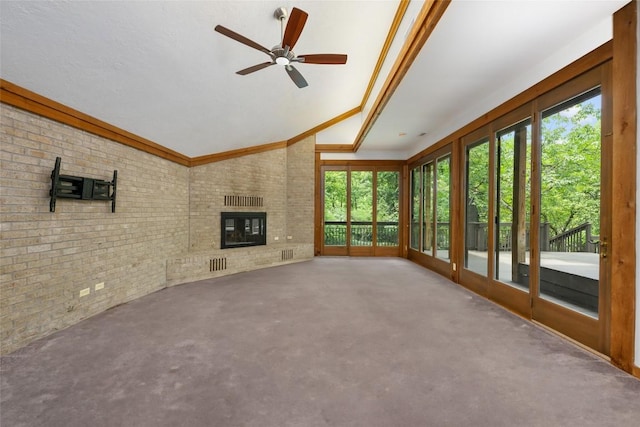 5902 Tumbling Cir, Austin, TX 78731 - unfurnished living room featuring brick wall, a ceiling fan, a fireplace, and lofted ceiling