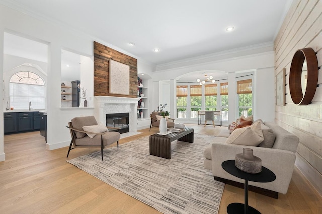 10239 Scull Creek Dr, Austin, TX 78730 - living room with crown molding, a chandelier, light wood-style floors, a fireplace with flush hearth, and recessed lighting