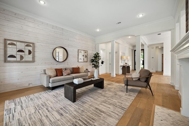 10239 Scull Creek Dr, Austin, TX 78730 - living room with light wood-style flooring, crown molding, wood walls, arched walkways, and recessed lighting