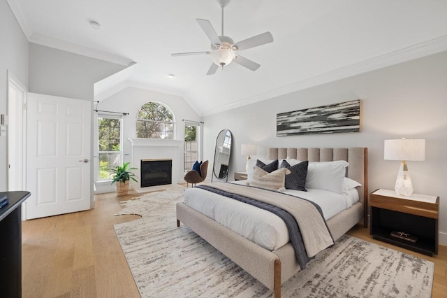 10239 Scull Creek Dr, Austin, TX 78730 - bedroom with a glass covered fireplace, light wood-style floors, lofted ceiling, crown molding, and a ceiling fan