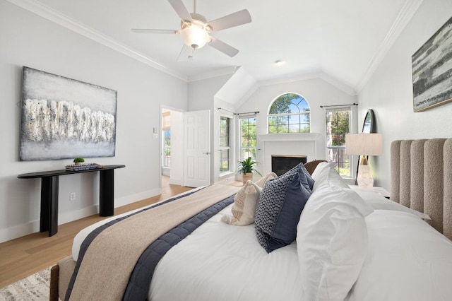 10239 Scull Creek Dr, Austin, TX 78730 - bedroom with wood finished floors, ornamental molding, a fireplace, lofted ceiling, and a ceiling fan