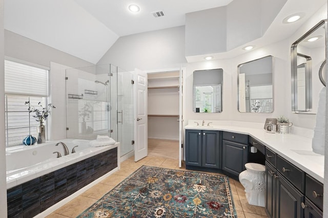 10239 Scull Creek Dr, Austin, TX 78730 - full bath featuring a stall shower, lofted ceiling, double vanity, tile patterned flooring, and a garden tub