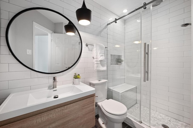 10239 Scull Creek Dr, Austin, TX 78730 - bathroom featuring a shower stall, vanity, and tile walls