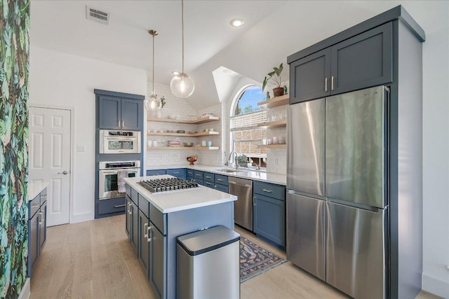 10239 Scull Creek Dr, Austin, TX 78730 - kitchen featuring stainless steel appliances, open shelves, backsplash, light countertops, and light wood-type flooring