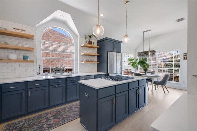 10239 Scull Creek Dr, Austin, TX 78730 - kitchen with open shelves, vaulted ceiling, stainless steel appliances, decorative backsplash, and light countertops