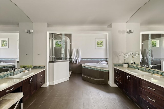 3604 Shady Creek Cv, Austin, TX 78746 - full bathroom featuring a garden tub, a stall shower, two vanities, and plenty of natural light