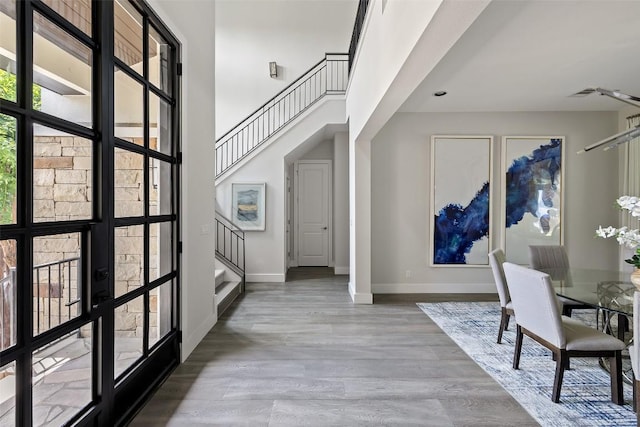 3604 Shady Creek Cv, Austin, TX 78746 - entrance foyer featuring stairway, wood finished floors, and a high ceiling