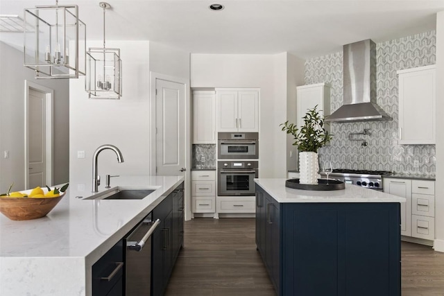 3604 Shady Creek Cv, Austin, TX 78746 - kitchen featuring wall chimney exhaust hood, a kitchen island with sink, appliances with stainless steel finishes, and dark wood finished floors