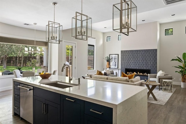 3604 Shady Creek Cv, Austin, TX 78746 - kitchen featuring a chandelier, open floor plan, dark wood finished floors, an island with sink, and light countertops