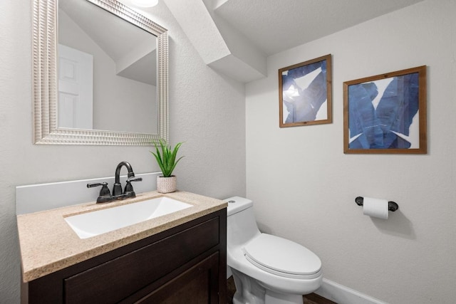 122 Retama Dr, Georgetown, TX 78626 - half bathroom featuring toilet, vanity, and baseboards